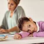 Child struggling to concentrate during homework while parents show concern, highlighting early ADHD symptoms and the importance of professional support.