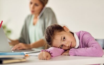 Child struggling to concentrate during homework while parents show concern, highlighting early ADHD symptoms and the importance of professional support.